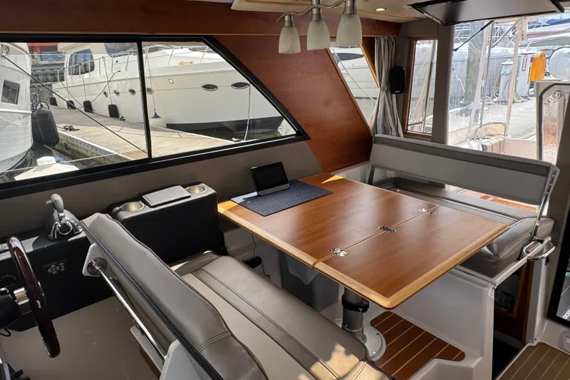 Slide: The Image of Interior of 2020 Cutwater C-30 CB boat with dining area and helm station. - 17