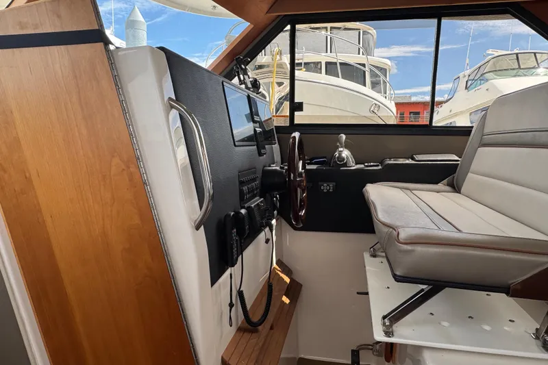 Slide: The Image of Interior helm of 2020 Cutwater C-30 CB boat with steering wheel and controls. - 18