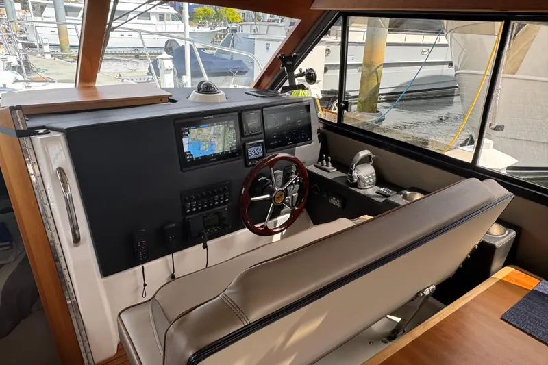Slide: The Image of Interior helm of 2020 Cutwater C-30 CB boat with navigation screens and controls. - 19