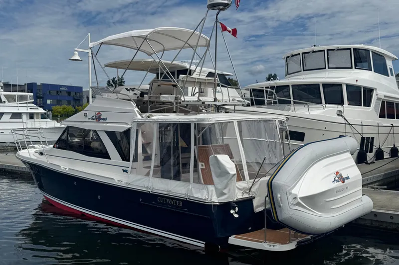 Slide: The Image of 2020 Cutwater C-30 CB boat docked with inflatable dinghy attached. - 3