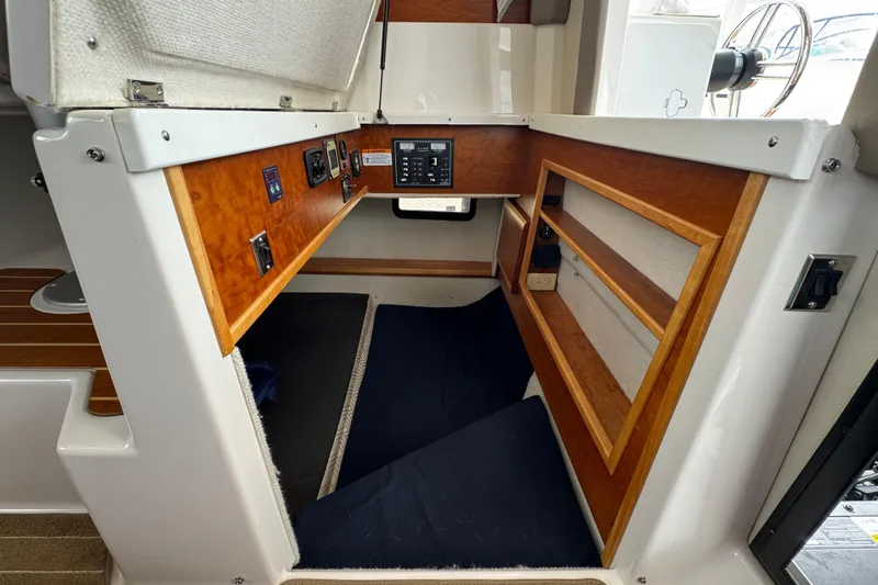 Slide: The Image of 2020 Cutwater C-30 CB cabin interior with control panel and wooden shelving. - 33