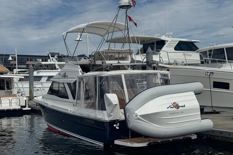 Slide: The Image of 2020 Cutwater C-30 CB boat docked with inflatable dinghy, marina background. - 4