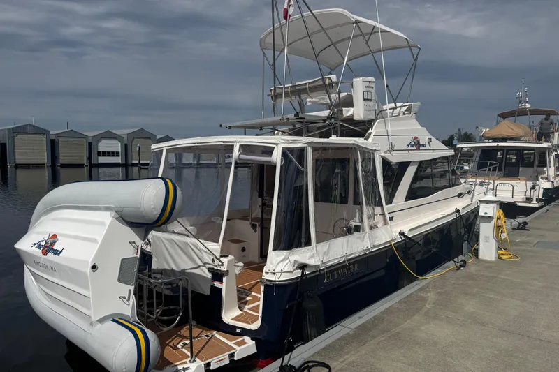 Slide: The Image of 2020 Cutwater C-30 CB boat docked at marina with inflatable dinghy attached. - 6