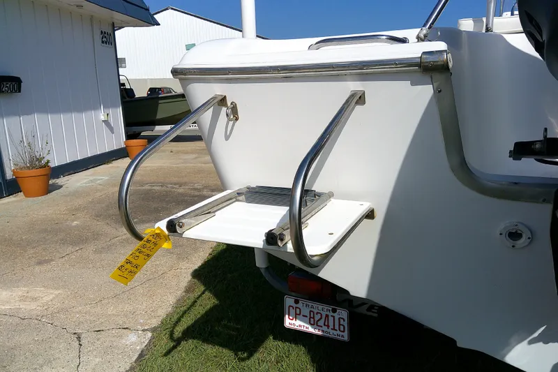 Slide: The Image of 2007 Sea Pro 186 CC boat with rear swim platform and ladder, parked outdoors. - 9