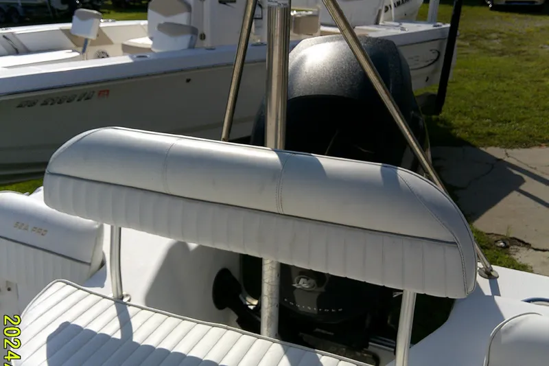 Slide: The Image of 2007 Sea Pro 186 CC boat interior with white seating and motor in background. - 19