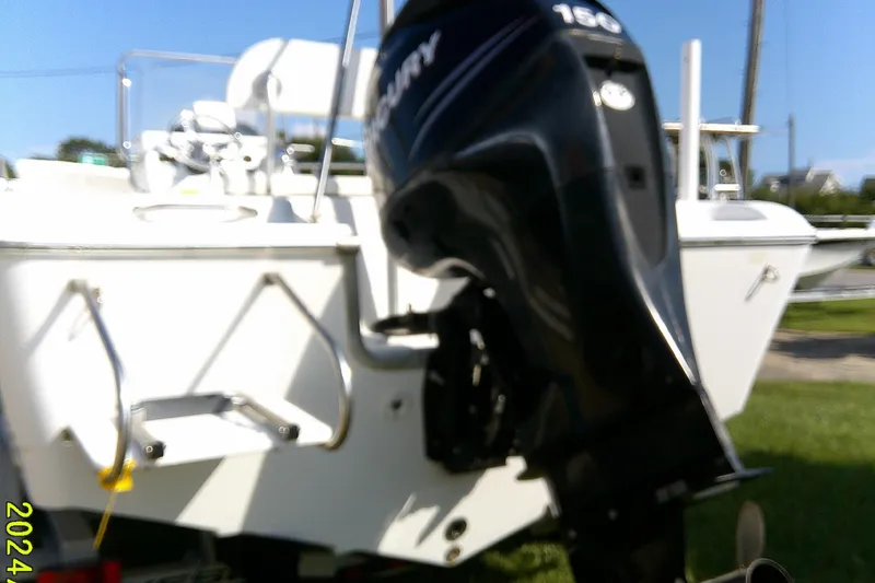 Slide: The Image of 2007 Sea Pro 186 CC boat with Mercury 150 outboard motor, parked on grass. - 6