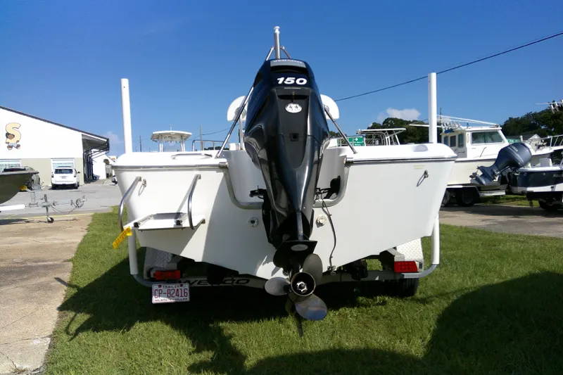 Slide: The Image of 2007 Sea Pro 186 CC boat with 150 HP engine, parked on grass under clear blue sky. - 7