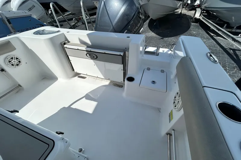 Slide: The Image of 2021 Sportsman Open 232 Center Console boat interior with seating and storage compartments. - 11