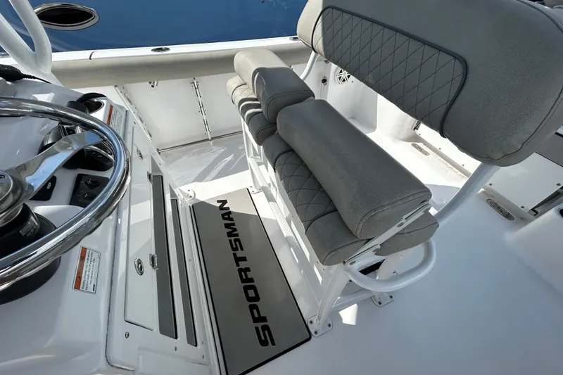 Slide: The Image of 2021 Sportsman Open 232 Center Console interior with steering wheel and cushioned seating. - 12