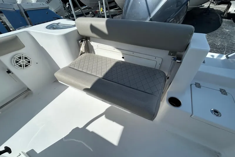 Slide: The Image of 2021 Sportsman Open 232 Center Console boat interior with cushioned seating and storage. - 14