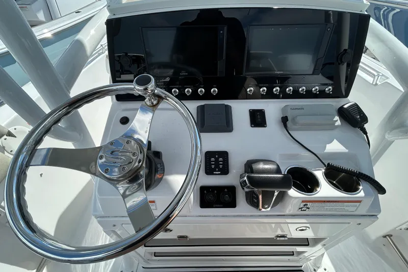 Slide: The Image of 2021 Sportsman Open 232 Center Console dashboard with steering wheel and navigation controls. - 15