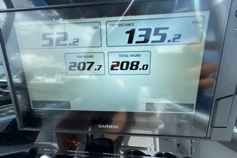 Slide: The Image of Garmin display on 2021 Sportsman Open 232 Center Console showing trip data and hours. - 17