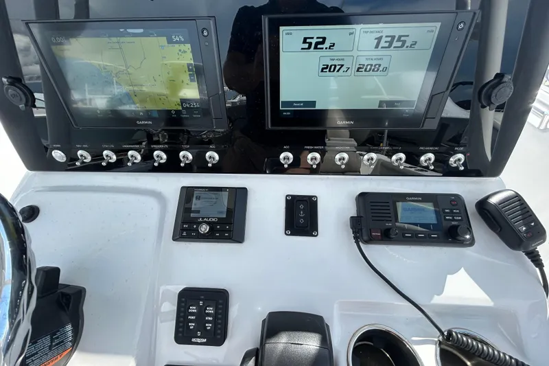 Slide: The Image of 2021 Sportsman Open 232 Center Console dashboard with Garmin displays and controls. - 18