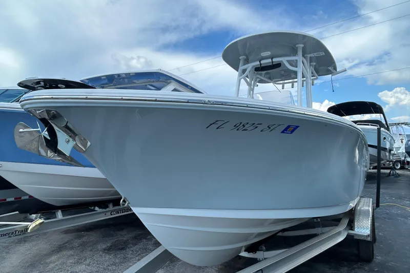 Slide: The Image of 2021 Sportsman Open 232 Center Console boat on trailer, displayed outdoors. - 2