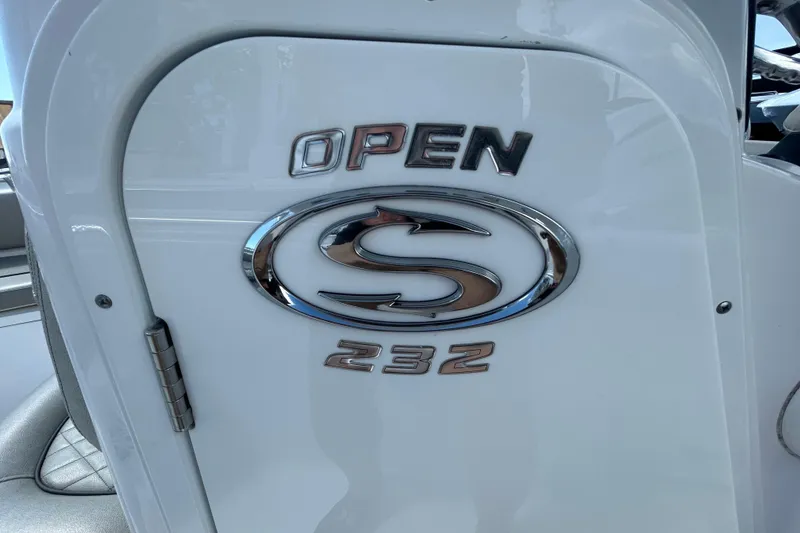 Slide: The Image of 2021 Sportsman Open 232 Center Console boat emblem on white surface. - 20