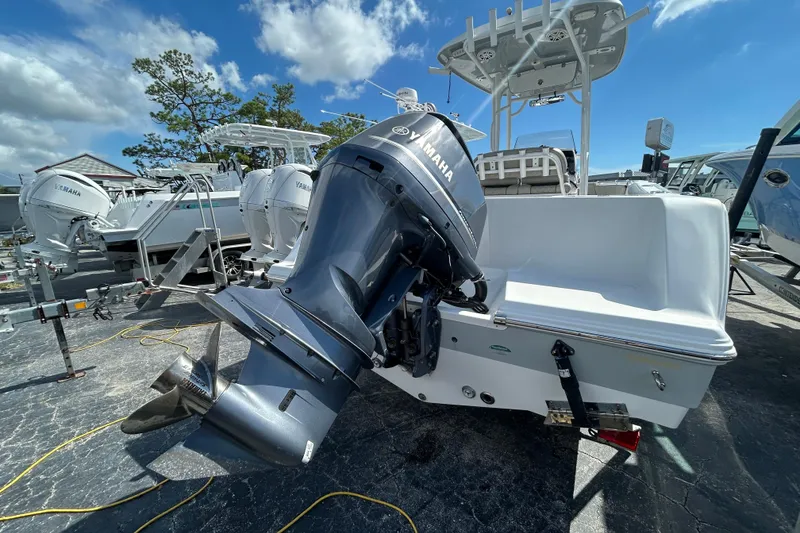 Slide: The Image of 2021 Sportsman Open 232 Center Console boat with Yamaha outboard motor, parked outdoors. - 5