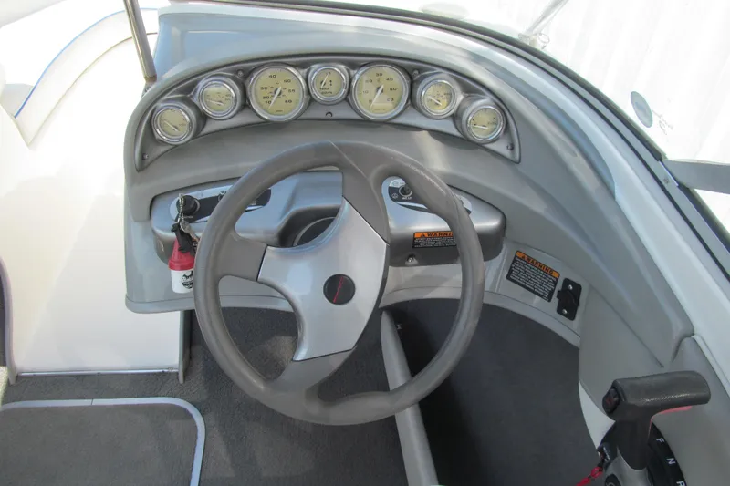 Slide: The Image of 2007 Bayliner 185 boat dashboard with steering wheel and gauges. - 6
