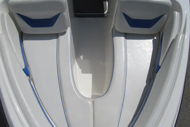 Slide: The Image of Interior seating of a 2007 Bayliner 185 boat, featuring white and blue upholstery. - 9