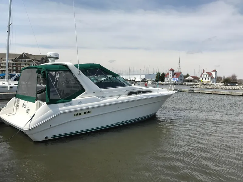 Slide: The Image of 1991 Sea Ray 310/330 Sundancer yacht docked in a marina. - 11