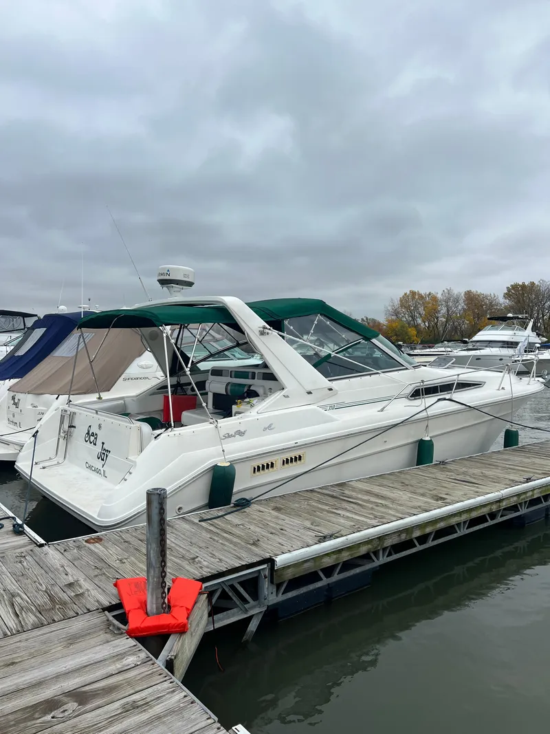 Slide: The Image of 1991 Sea Ray 310/330 Sundancer docked at a marina under cloudy skies. - 12