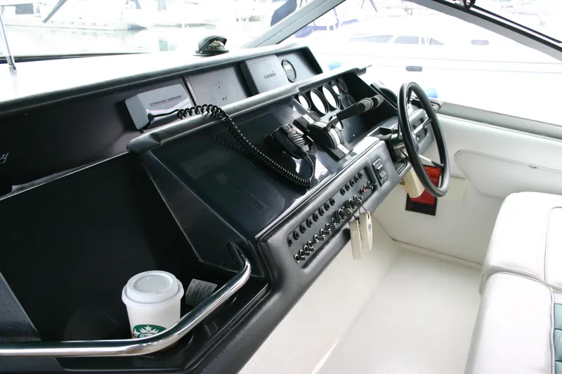 Slide: The Image of 1991 Sea Ray 310/330 Sundancer helm with steering wheel and control panel. - 13