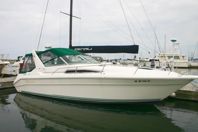 Slide: The Image of 1991 Sea Ray 310/330 Sundancer boat docked in marina, featuring green canopy. - 21