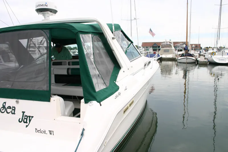 Slide: The Image of 1991 Sea Ray 310/330 Sundancer docked in marina, green canopy, "Sea Jay" on stern. - 22