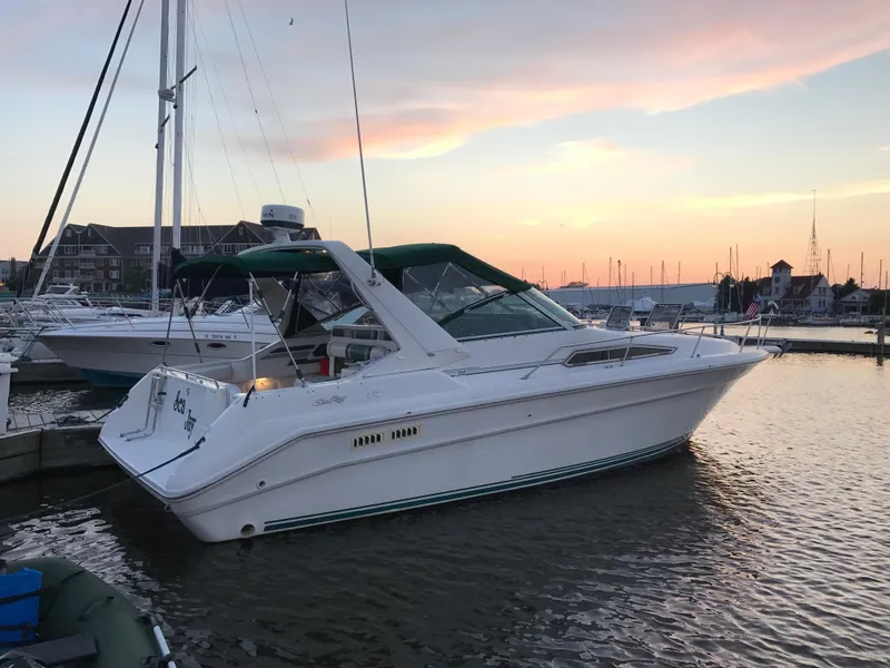 Slide: The Image of 1991 Sea Ray 310/330 Sundancer docked at sunset, marina background. - 4
