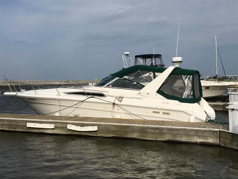 Slide: The Image of 1991 Sea Ray 310/330 Sundancer docked at marina, side view. - 5