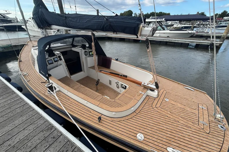 Slide: The Image of 2019 Saffier Sc 8.0m Cabin sailboat docked, featuring sleek wooden deck design. - 10