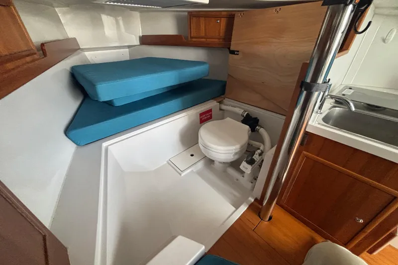 Slide: The Image of 2019 Saffier Sc 8.0m Cabin interior with compact toilet and blue cushions. - 11