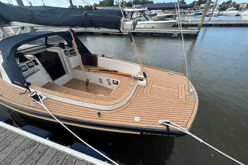 Slide: The Image of 2019 Saffier Sc 8.0m Cabin sailboat docked, featuring sleek wooden deck and modern cockpit. - 14