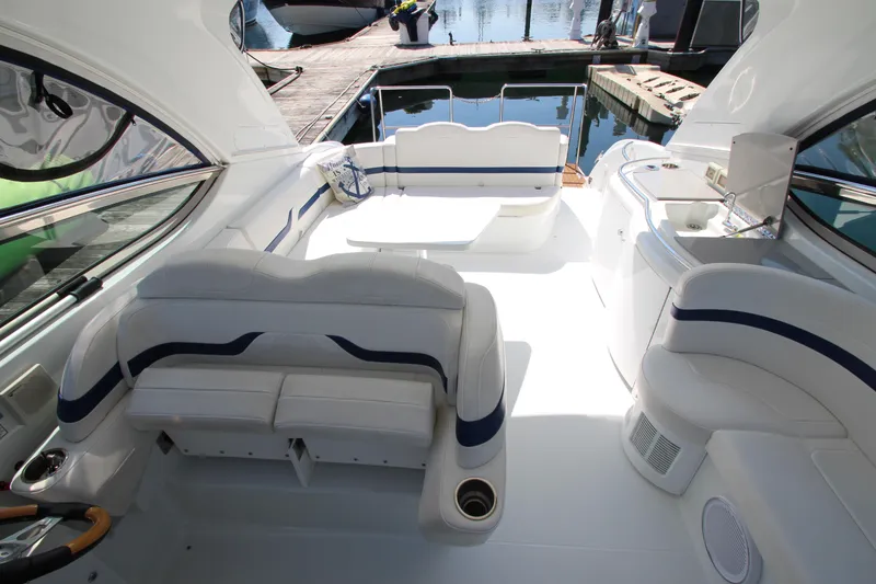 Slide: The Image of 2012 Formula 400 Super Sport boat interior with white seating and dock view. - 20
