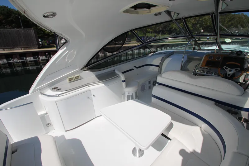 Slide: The Image of Interior of a 2012 Formula 400 Super Sport boat with white seating and table. - 32
