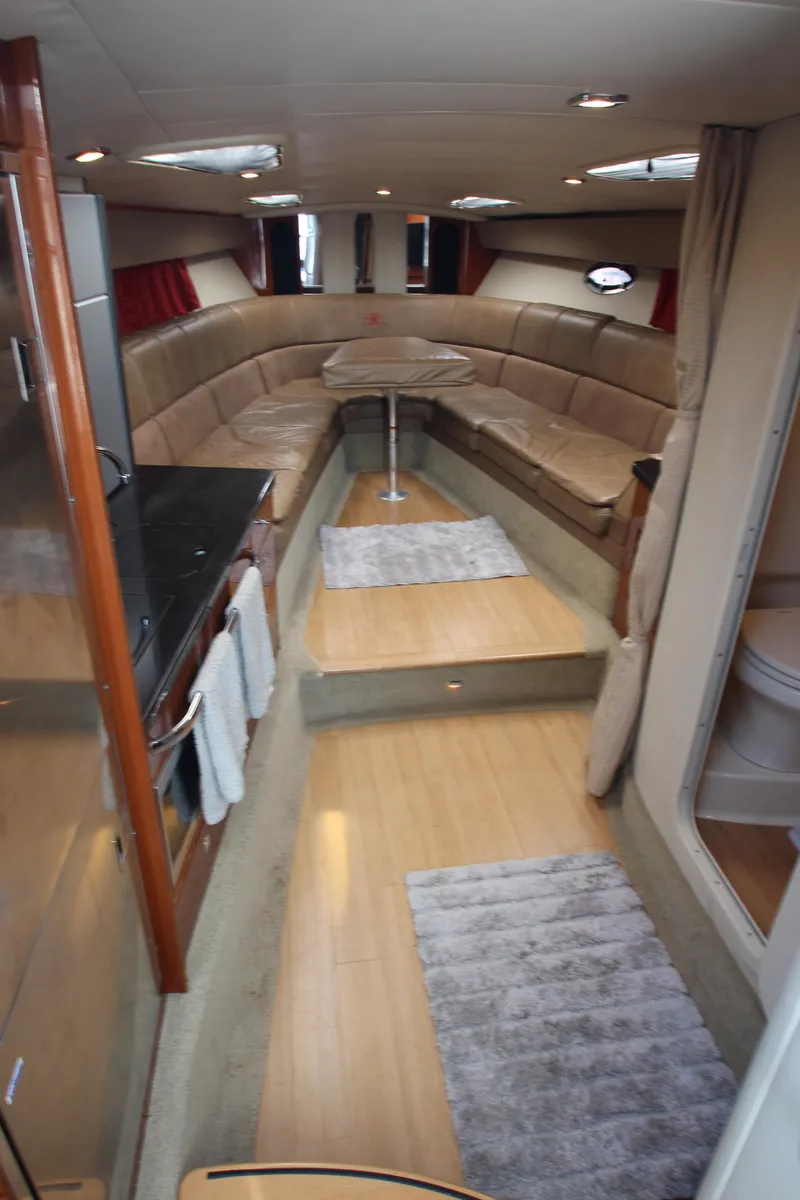 Slide: The Image of Interior of a 2012 Formula 400 Super Sport yacht with beige seating and wooden flooring. - 36