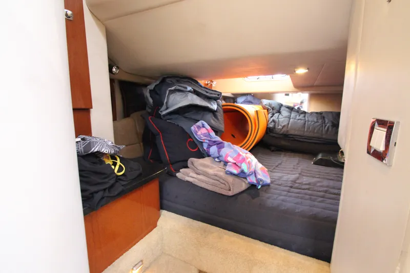 Slide: The Image of Interior cabin of a 2012 Formula 400 Super Sport boat with cluttered bedding. - 47