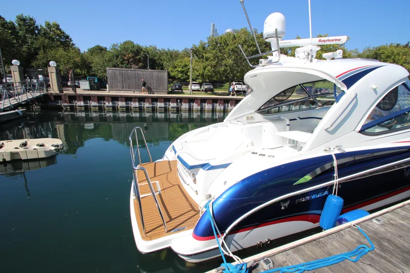 Slide: The Image of 2012 Formula 400 Super Sport yacht docked at a marina on a sunny day. - 7