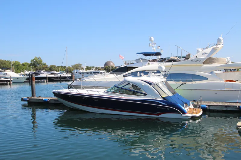 Slide: The Image of 2012 Formula 400 Super Sport yacht docked at a marina. - 9