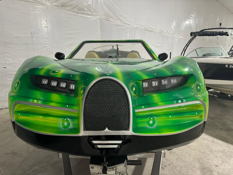 Slide: The Image of 2023 Watersports Car Series B with vibrant green design in a showroom. - 14