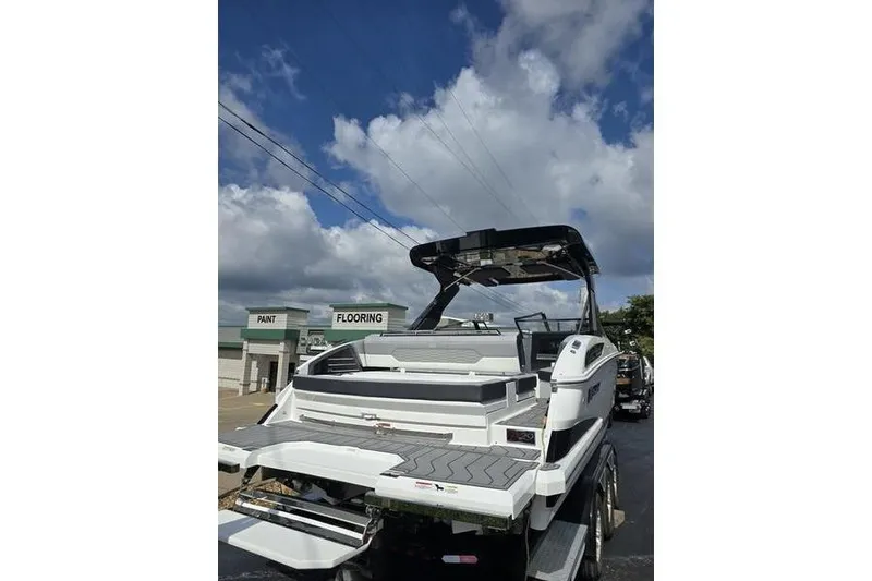 Slide: The Image of 2026 Cobalt A29 boat with sleek design, parked outdoors under a cloudy sky. - 11