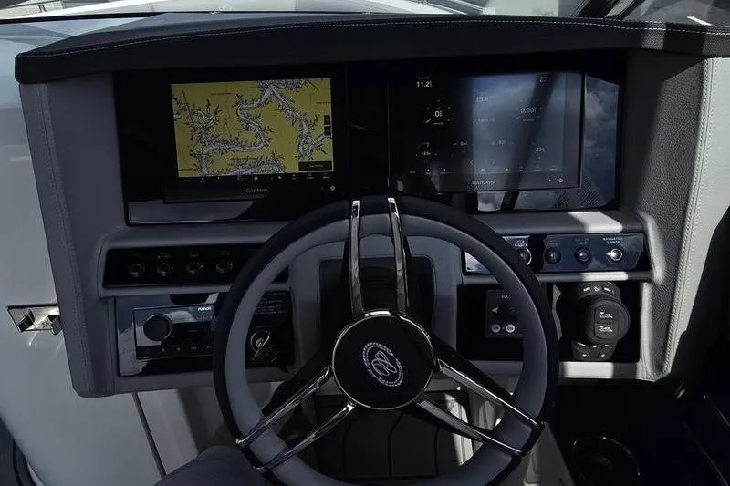 Slide: The Image of 2026 Cobalt A29 boat dashboard with navigation screens and steering wheel. - 7