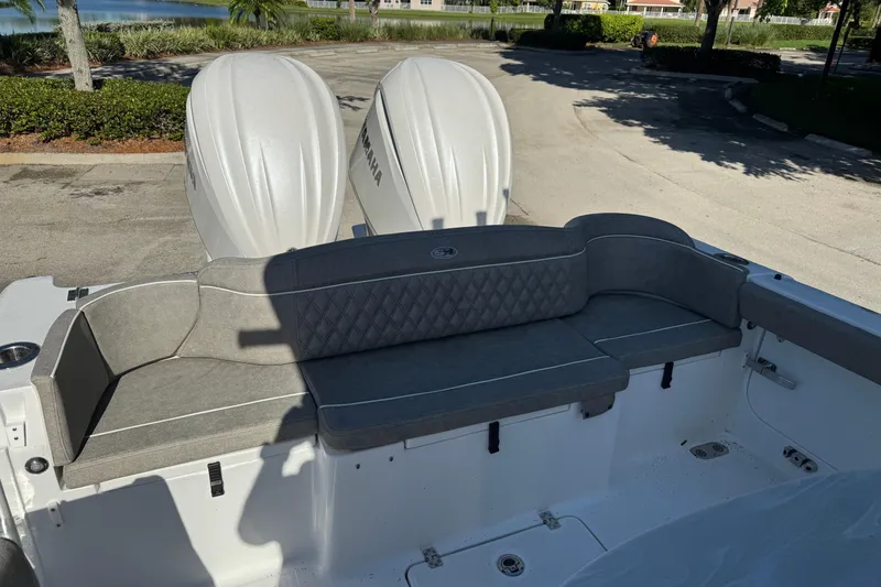 Slide: The Image of 2025 Sea Hunt Ultra 305 SE boat with dual Yamaha engines and cushioned seating. - 5