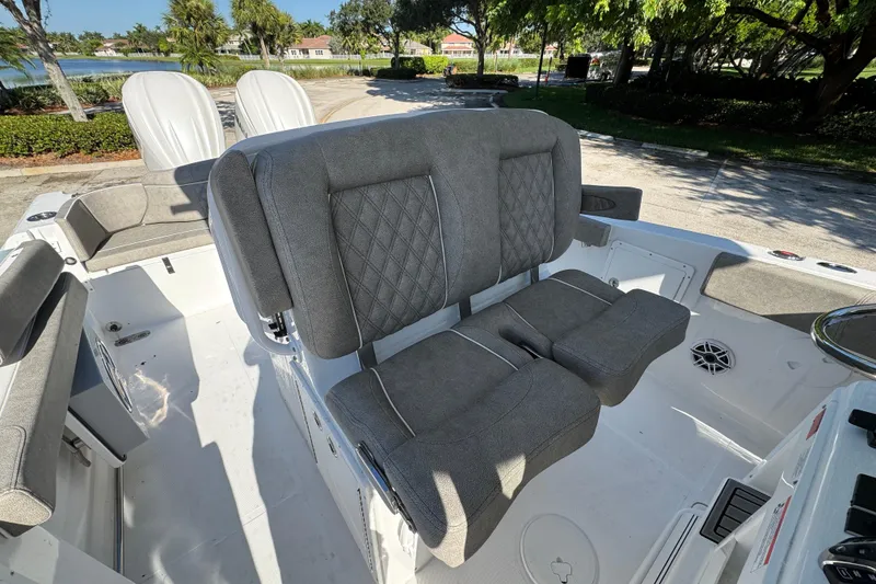 Slide: The Image of 2025 Sea Hunt Ultra 305 SE boat interior with gray cushioned seating. - 7