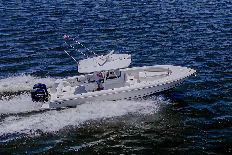The Image of 2010 Intrepid 323 OPEN boat cruising on open water, showcasing sleek design and performance. - 0