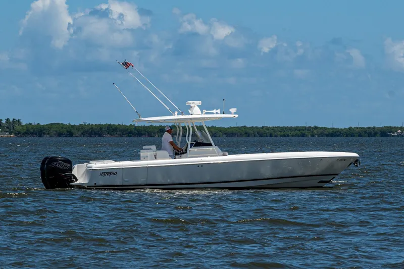 Slide: The Image of 2010 Intrepid 323 OPEN boat cruising on a sunny day with clear skies. - 10