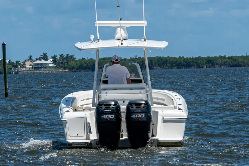 Slide: The Image of 2010 Intrepid 323 OPEN boat cruising on open water with dual engines. - 11