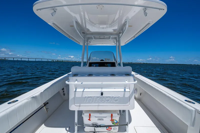 Slide: The Image of 2010 Intrepid 323 OPEN boat on water, clear sky, bridge in background. - 17