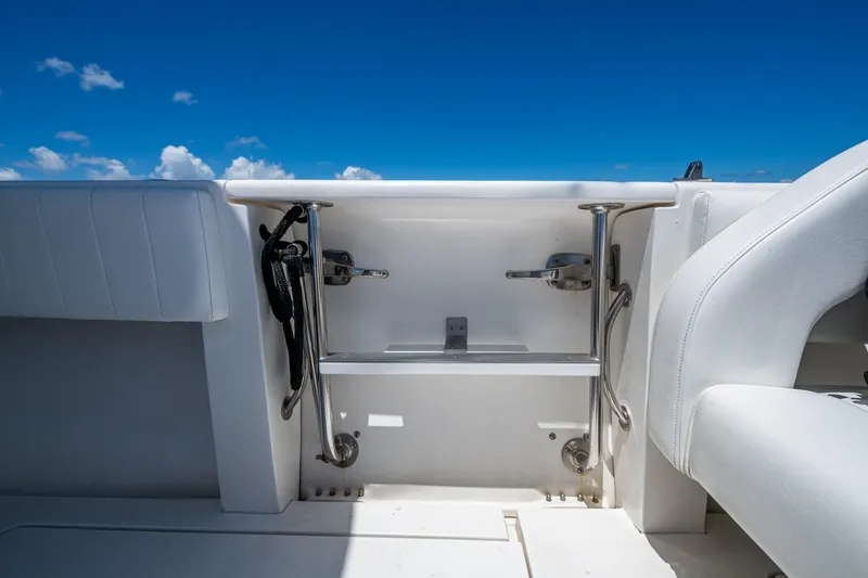Slide: The Image of 2010 Intrepid 323 OPEN boat interior with white seating and stainless steel fittings. - 19