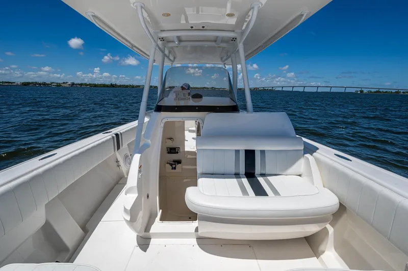 Slide: The Image of 2010 Intrepid 323 OPEN boat interior with seating, on a sunny day at sea. - 22
