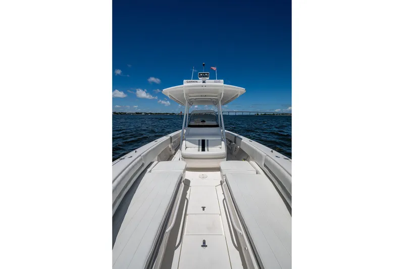 Slide: The Image of 2010 Intrepid 323 OPEN boat on calm water under clear blue sky. - 24
